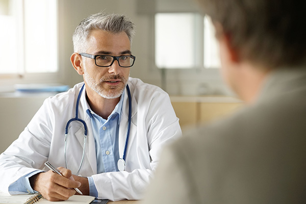Consultant radiologist discussing patient care in a medical office.