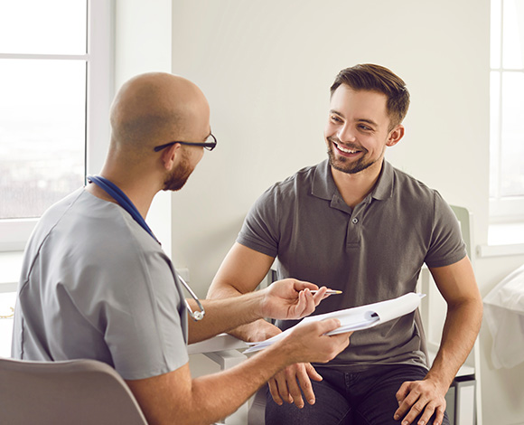 Consultation between a doctor and a patient in a medical office.