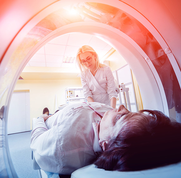 Radiologist assisting a patient in a CT scanner at SHB Medical Imaging.
