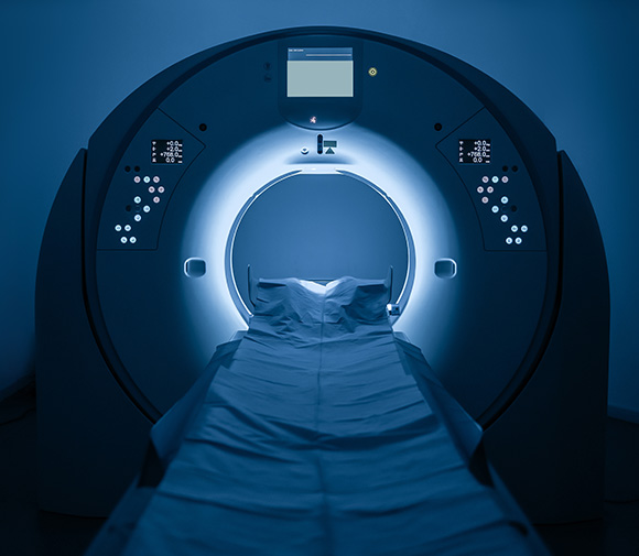 Cardiac CT scanner with a patient table in a well-lit examination room